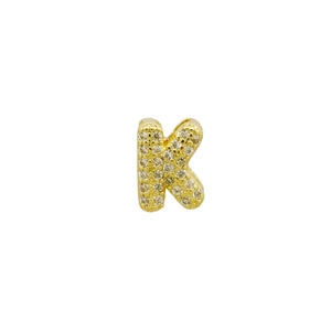 Close-up of golden letter K pendant with sparkling micro-pave cubic zirconia crystals