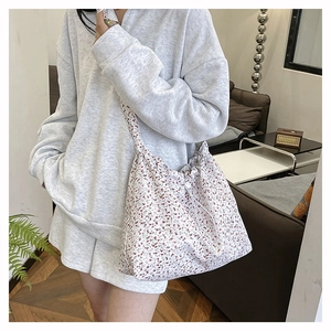 Floral canvas crossbody bag detail showing drawstring closure and spacious design