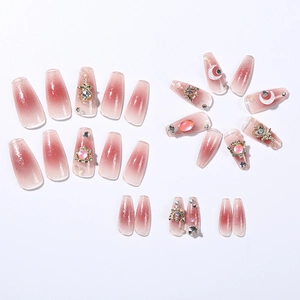 Detailed flat lay of 24 pink gradient trapezoid press-on nails with pearls and rhinestones