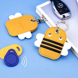 Cute bee-shaped leather AirTag and RFID card holder case with metal keychain set