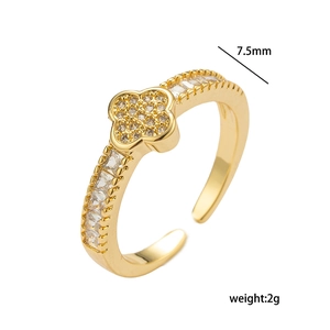 Golden four-leaf clover open ring with sparkling zircons on a clean white background