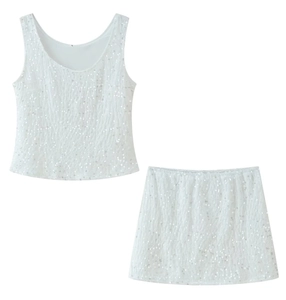 Close-up detail of white sequin texture on two-piece tank top and skirt set
