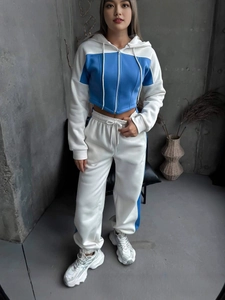 Tuta sportiva da donna blu e bianca con felpa con cappuccio e pantaloni coordinati