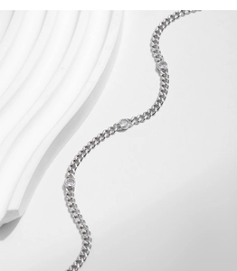 Detailed view of s925 silver Cuban chain bracelet with round Moissanite stones on a stone base