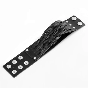 Detail of black woven leather wristband featuring adjustable metal snap fasteners