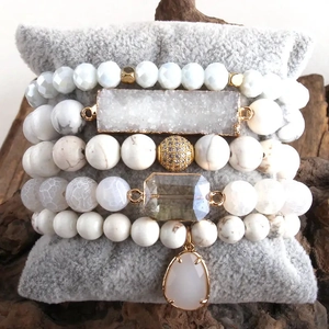 Close-up of a 5-piece white bohemian stackable bracelet set with druzy stone and crystals