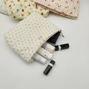 Quilted floral and bear cosmetic bag showing large storage capacity for beauty products
