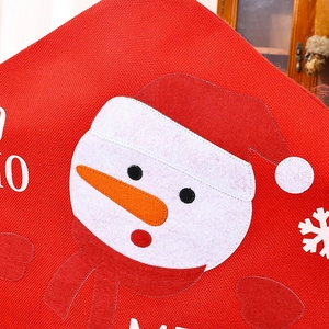 Detail of Christmas chair cover showing red burlap fabric with snowman appliqué and embroidery