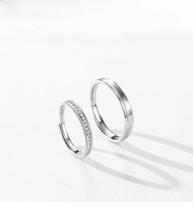 Detail of s925 silver couple rings with micro-set zircons and brushed matte finish