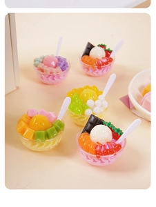 Detailed view of miniature fruit dessert bowl models with ice cream and tiny resin spoons