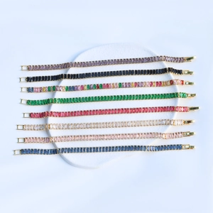 Close-up of gold-plated tennis bracelets with colorful rectangular zircon stones on tray