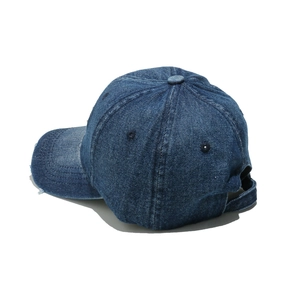 Detail of distressed brim and adjustable strap on dark blue denim baseball cap