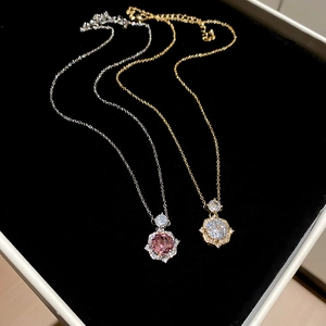 Close-up of 14k gold-plated rose flower pendant necklaces with zircon crystals