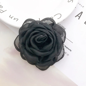 Detail of a black lace and satin layered 3D rose flower for DIY accessories