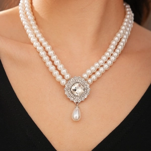 Close-up of double-layer pearl necklace with square rhinestone pendant and teardrop pearl