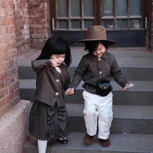 Retro grey tweed jacket set with skirt and sun hat for children on outdoor stairs