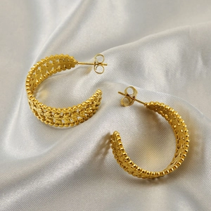 Golden wheat ear hollow hoop earrings crafted in stainless steel on white silk fabric