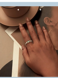 Elegant s925 silver open ring featuring an oval green zircon stone worn on a finger