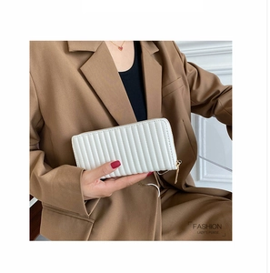 Detailed view of white quilted PU leather clutch wallet with gold zipper for women
