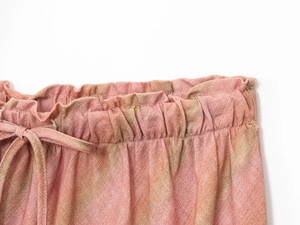 Detail of peach pink linen midi skirt waist with elastic band and matching drawstring