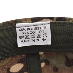 Detail shot of camouflaged cap interior showing wash label with cotton blend material info
