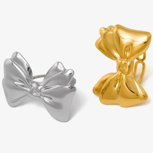 Detail of 304 stainless steel bow rings in gold and silver with polished mirror finish