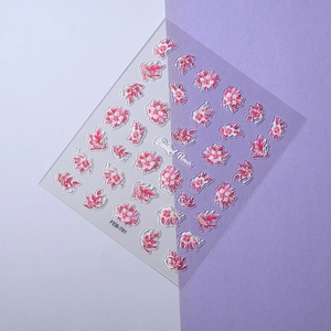 Macro detail of blue floral nail stickers featuring pink flowers and leaf patterns