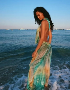 Detail of the high side slit and flowy tie-dye chiffon fabric on a beach maxi dress