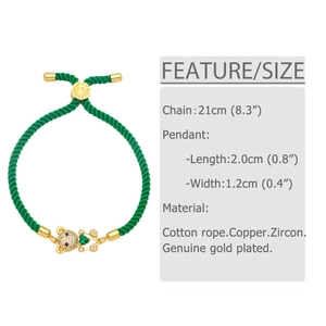 Detail of green woven rope bracelet with gold-plated bear pendant and green heart zircon