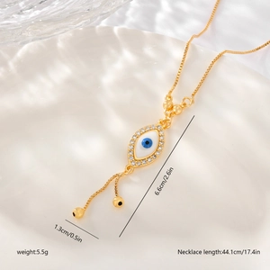 Detail shot of gold Evil Eye necklace with dimensions 6.6cm x 1.3cm and 44.1cm length