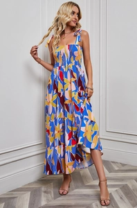 Detail of blue floral maxi dress with tiered skirt and tie straps on indoor model