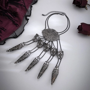 Detail of Gothic slave bracelet with intricate filigree center and finger rings