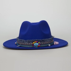 Detail of bohemian fedora hat with ethnic woven band, turquoise stone and blue tassels
