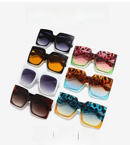 Flat lay of square sunglasses in multiple leopard prints and gradient lenses