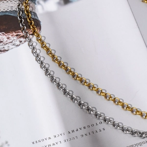 Detail of round interlocking Rolo chains in gold and silver finish stainless steel