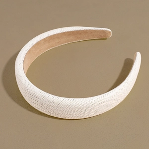 Macro shot of white straw woven texture and light brown inner lining on the headband