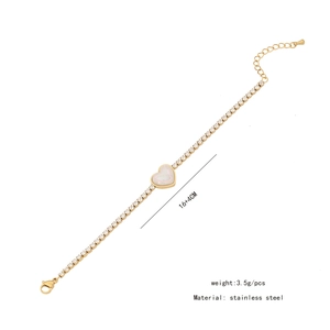Detailed macro view of gold stainless steel heart bracelet with shell inlay and cubic zirconia