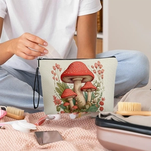 Portable canvas makeup bag with vintage mushroom print and black zipper on warm background