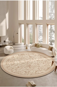 Detail of round beige floral rug in a bright minimalist living room setting