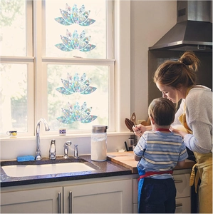 Rainbow prism lotus window decals casting colorful light in a sunny kitchen setting