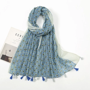 Close-up detail of lightweight floral cotton linen scarf with blue decorative tassels