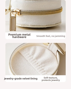 Detail of premium golden metal zipper and soft white velvet lining of round jewelry box