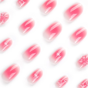 Pink gradient press-on nails with white heart and star patterns and 3D flower accents
