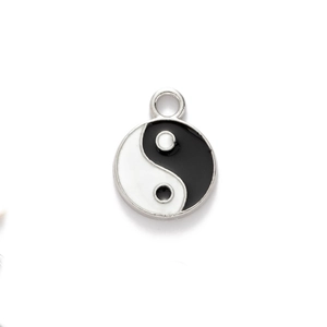 Close-up of yin yang pendant with black and white enamel finish on silver metal ring