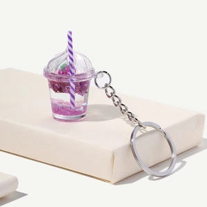 Detailed view of creative purple bubble tea keychain with fluid and floral glitters