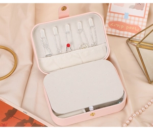 Pink PU leather travel jewelry box with interior hooks and compartments for necklaces