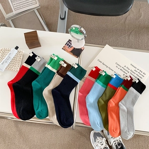 Macro shot of assorted colorful ribbed knit crew socks with distinctive NT woven labels