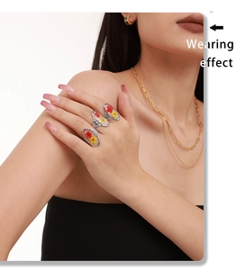 Detail showing wearing effect of vintage silver rings with dried flower resin inlay
