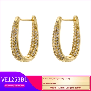 Detail view of gold brass U-shaped hoop earrings with micro-pave cubic zirconia settings