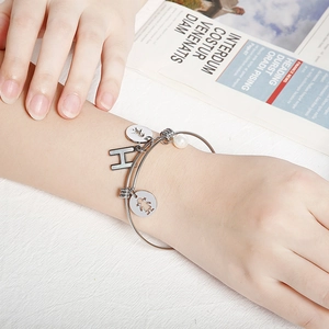 Adjustable silver steel bracelet with letter H pendant, girl charm, and white pearl